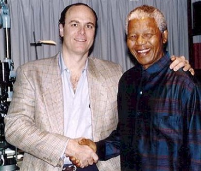 Richard Weiss, M.D. shakes hands with late former South African President Nelson Mandela.